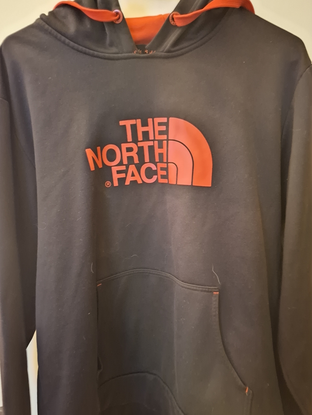 The North Face Black Hoodie with Orange Logo